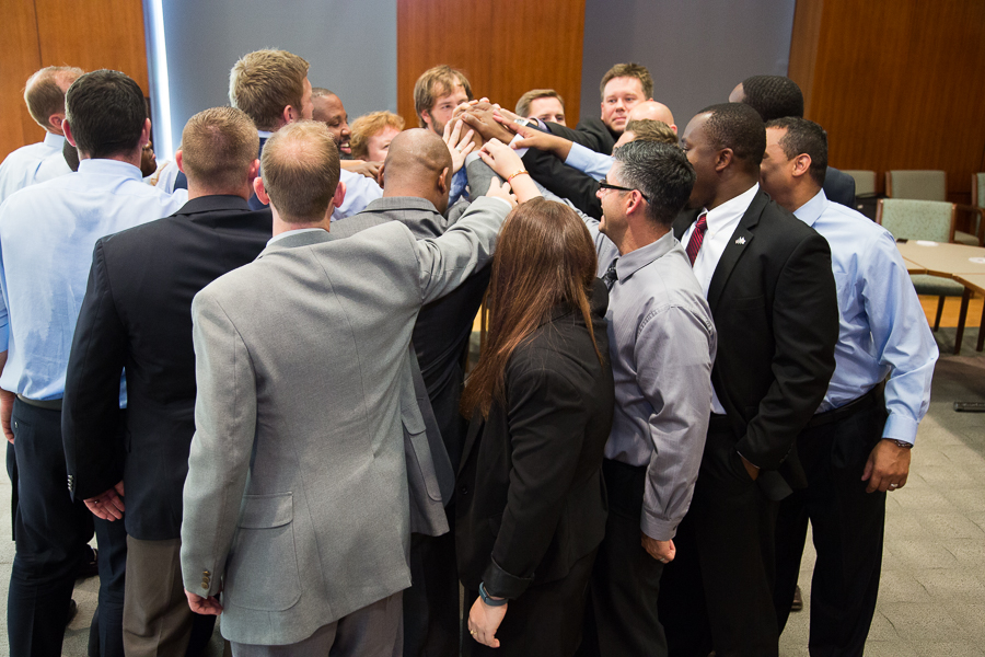 Group of people putting hands together