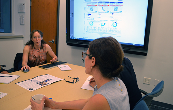 two women talking at conference table