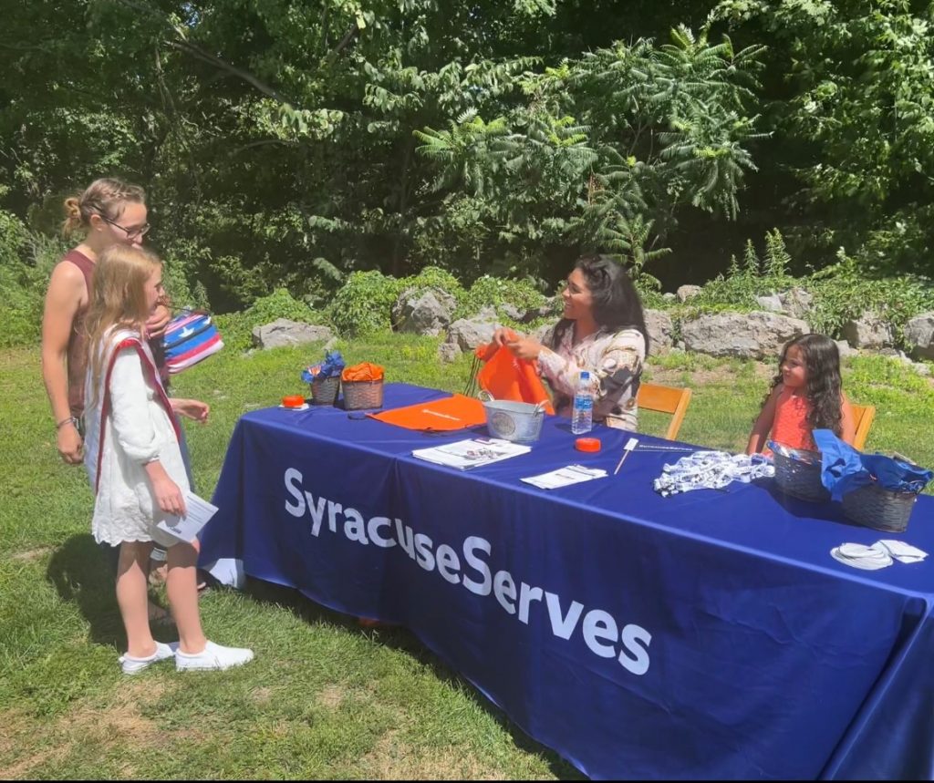 Ke'airah parker, Syracuse Serves program manager, handing out back to school supplies.