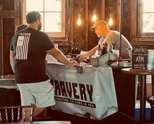 Corey founder of Bravery wines working a tasting table