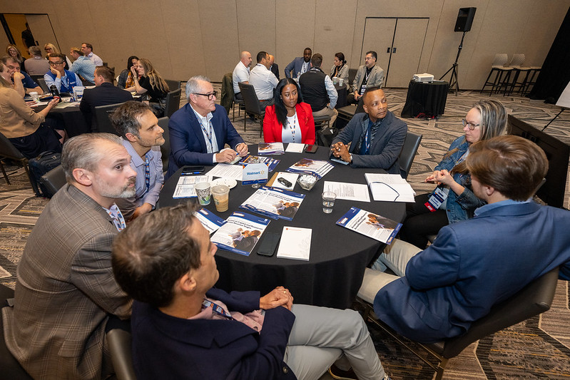 Edge participants discussing business around a conference table.