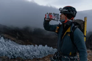 Man drinking meal replacement in cold gear.