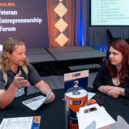 Two veterans discussing business at Veteran entrepreneurship forum