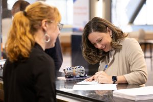 Veteran edge participant signing paper.