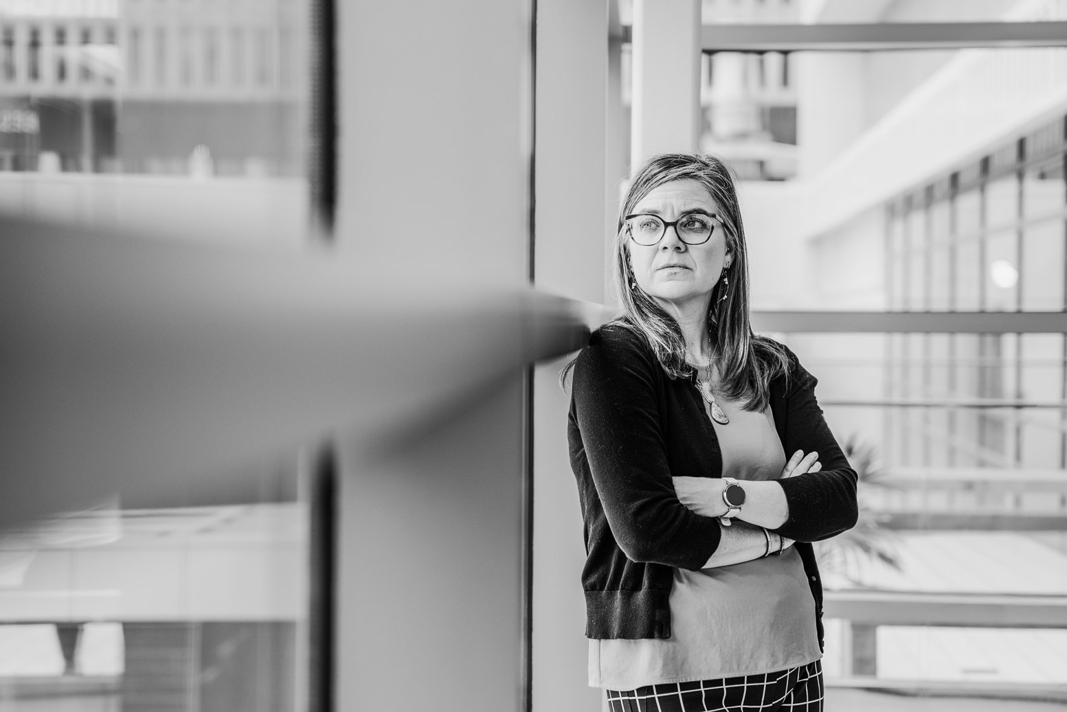 Military spouse leaning against a wall.