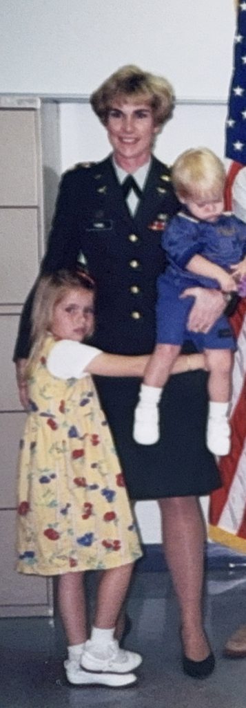 Kathleen in dress uniform holding her children