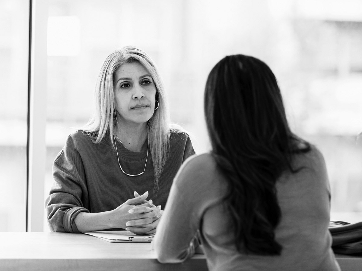Two military spouses talking at a table. 