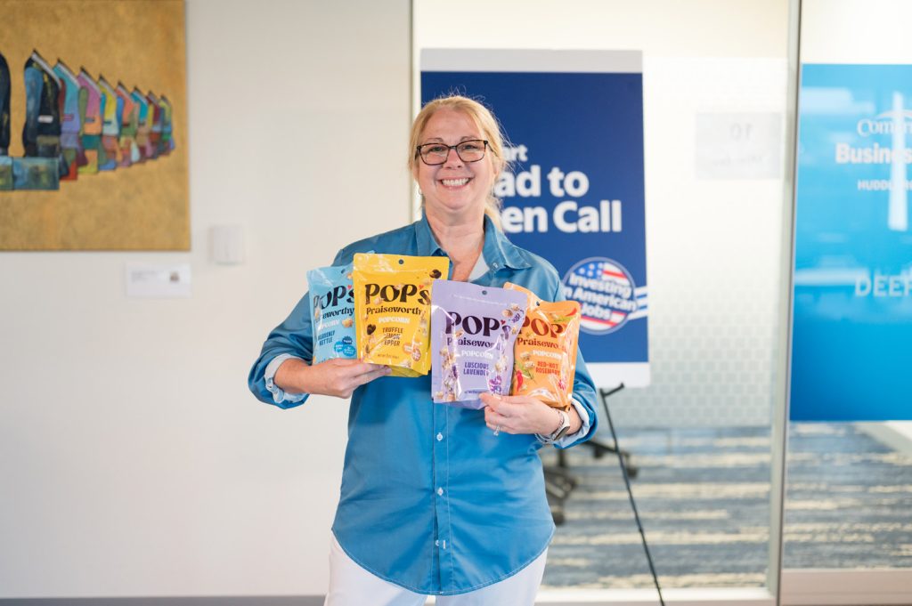 Nicole Brown at Walmart open Call holding her product Pop.
