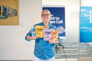 Nicole Brown at Walmart open Call holding her product Pop.