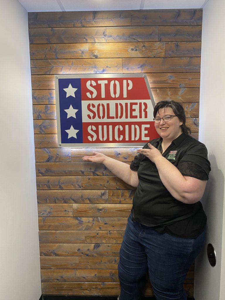 Belverly Cutchins posing with stop soldier suicide sign
