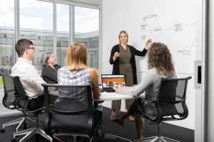 Team members discuss the IVMF Digital Library.