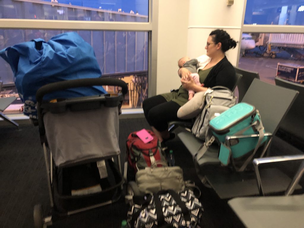 Jenifer in an airport with her newborn during a PCS